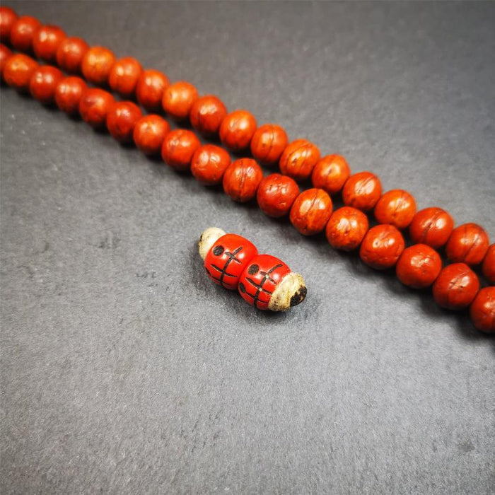 1 Pair of Plastic Skull Beads 0.4" - Tibetan Buddhist art, close-up detail
