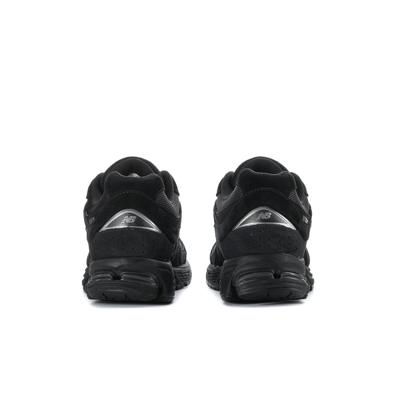 Men's black sneakers rear view with padded heel and textured rubber outsole