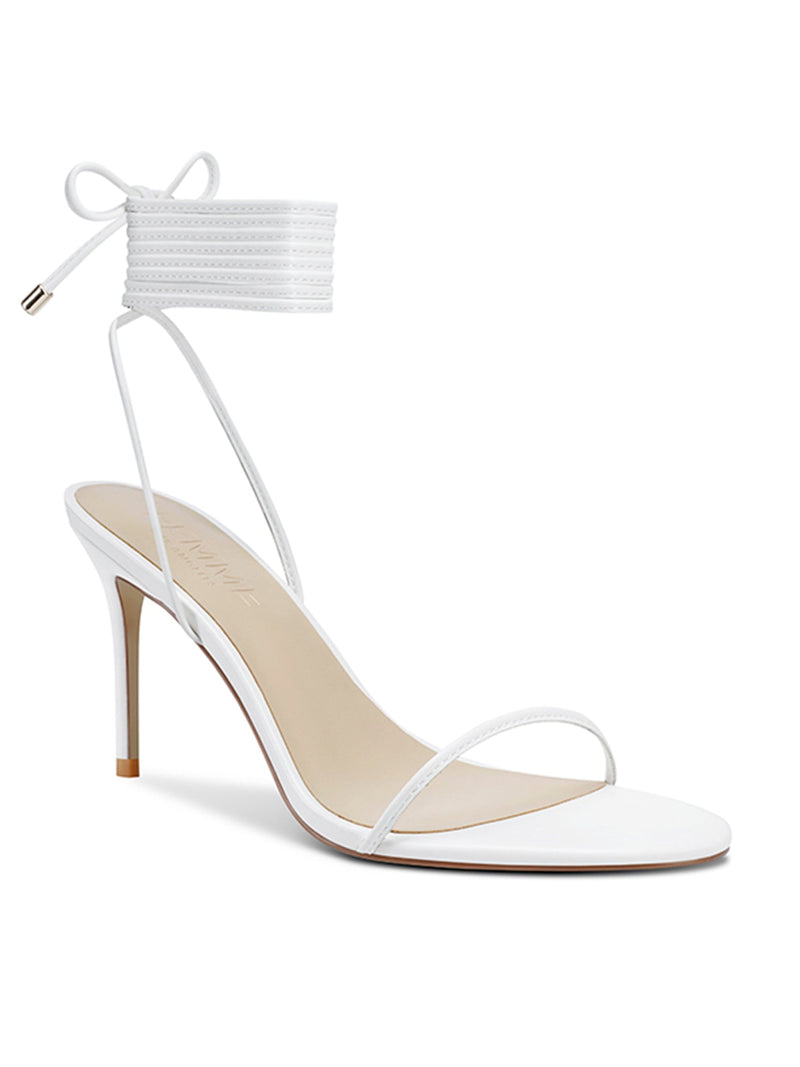 FEMME LA 3.0 Barely There Lace Up Heel in white — front three-quarter view showing thin toe strap, multi-wrap ankle cuff, and gold aglet detail