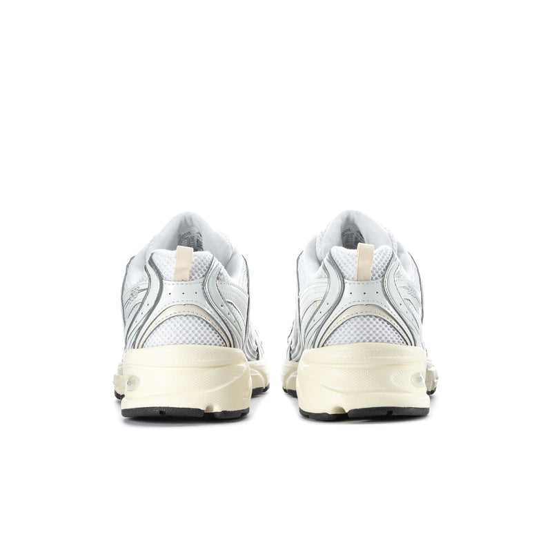 Men's athletic sneakers, heel view: silver upper with cream midsole and lace-up