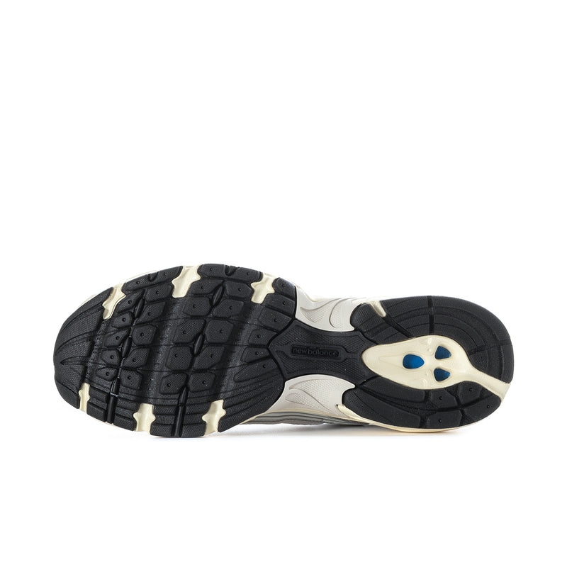 Men's athletic sneakers outsole: black tread with cream midfoot panel and blue accent