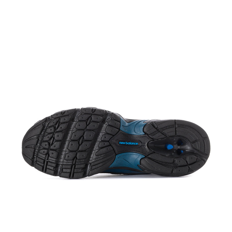 New Balance sneakers outsole view, textured rubber tread in black with blue trim.