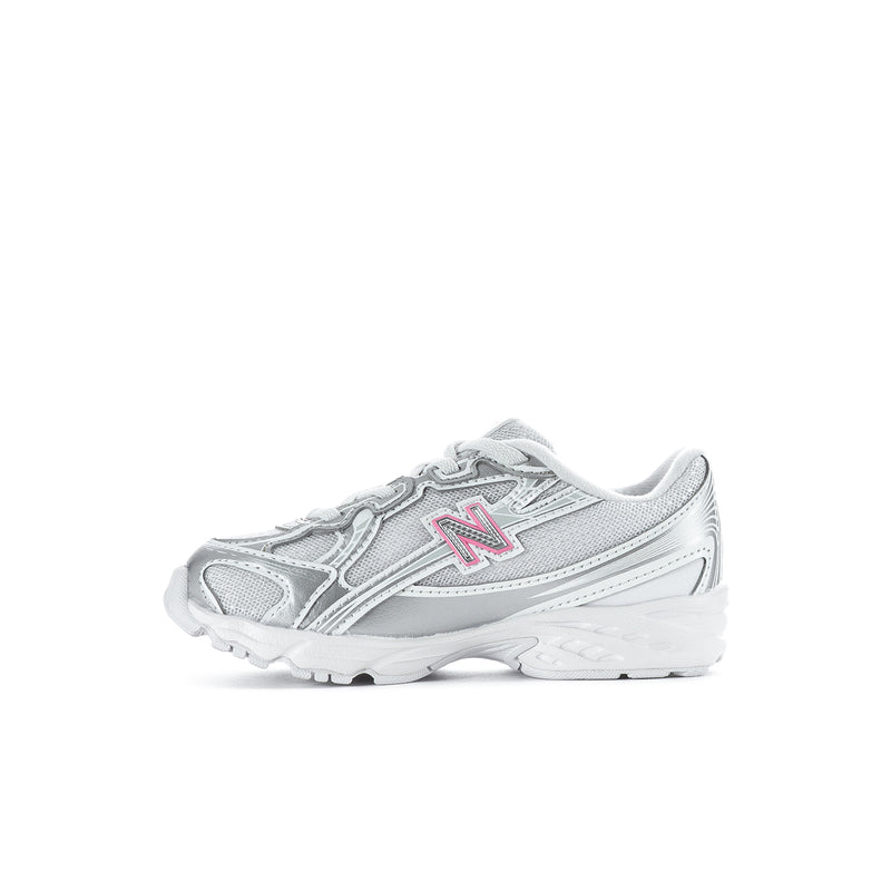 Silver toddler sneaker with pink N logo, layered straps and textured outsole.