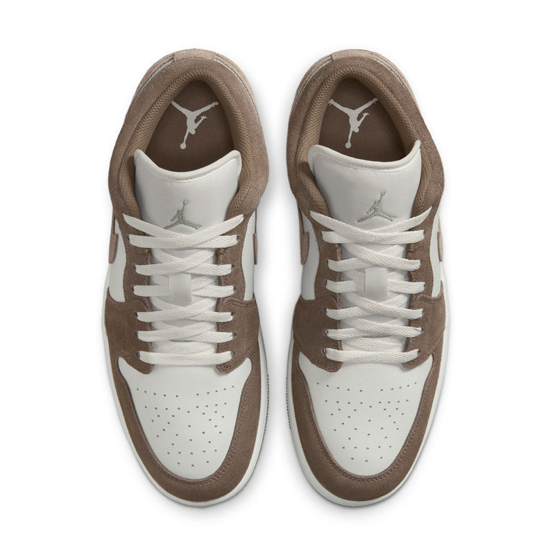Men's low-top sneakers with white laces and brown suede overlays, viewed from above