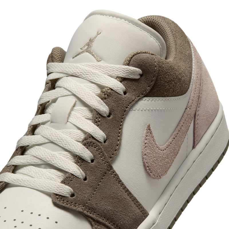 Men's low-top sneaker upper close-up with white laces and brown suede panels