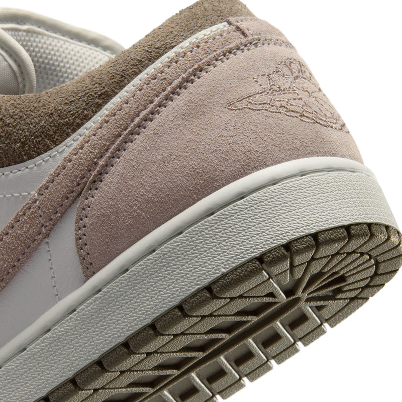 Men's sneaker outsole close-up with brown tread and rubber traction grooves