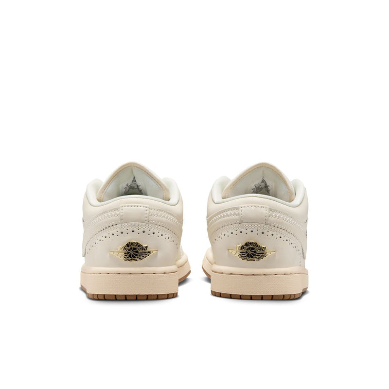 Women’s cream low-top sneakers from the heel, gold wing emblem and gum outsole.
