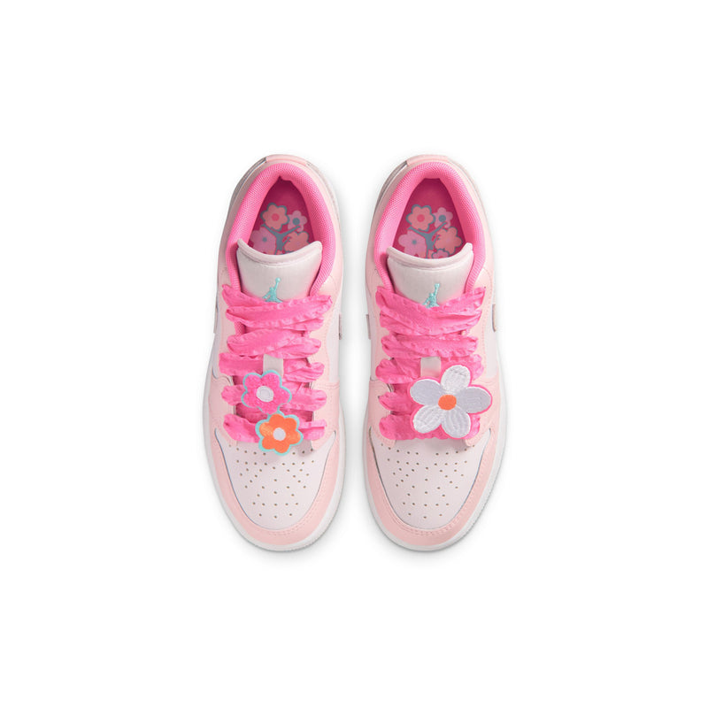 Youth sneakers pair with pink laces and flower applique on the tongue and side