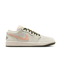 Women's low-top sneaker in off-white with pink swoosh, olive laces, and gum sole