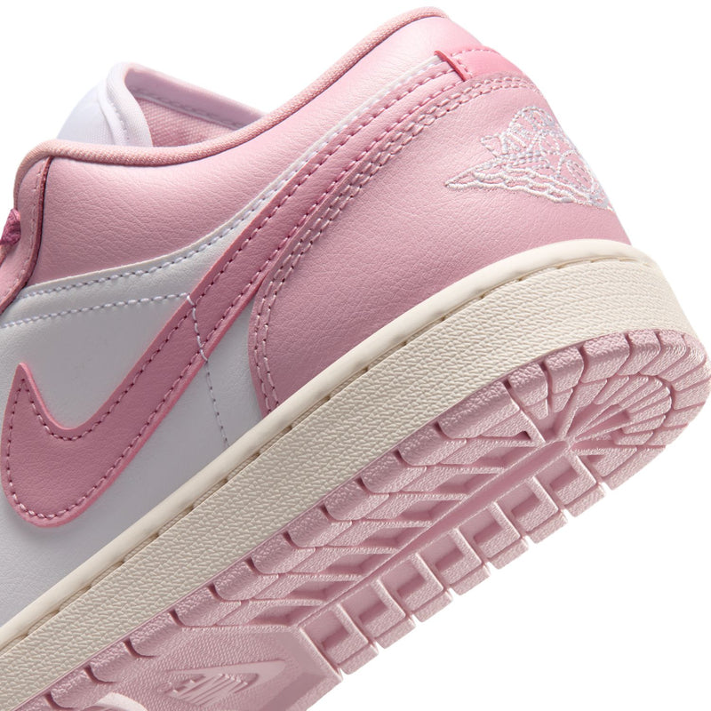 Women's sneaker side close-up in pink and white with outsole tread detail