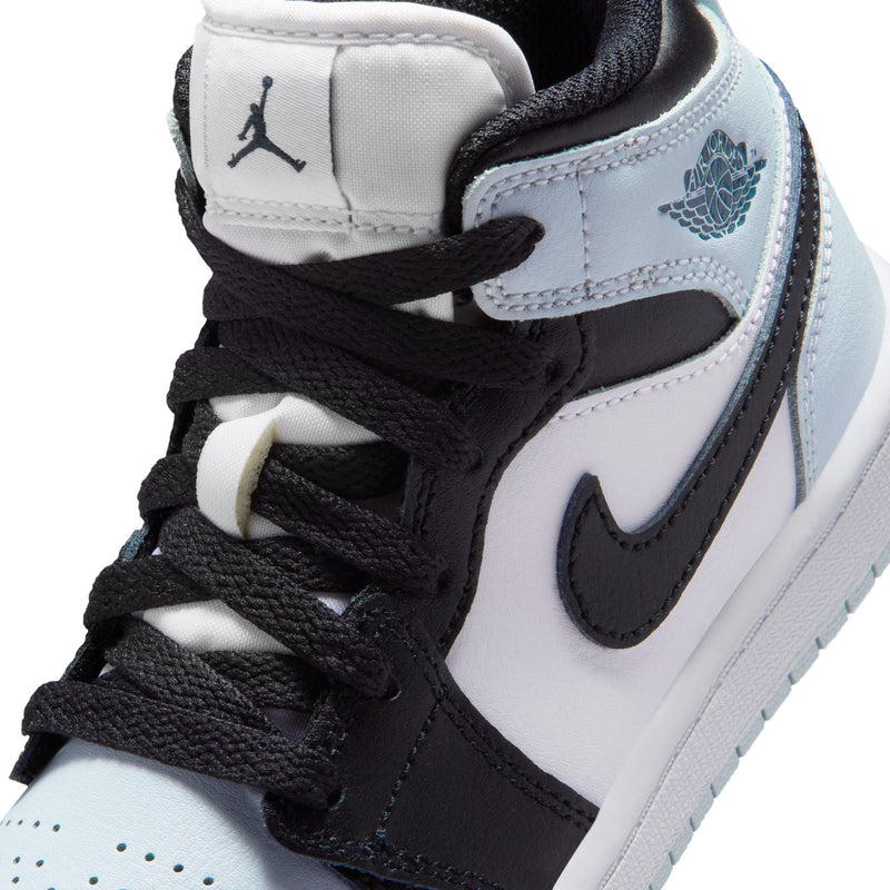 Kids mid-top sneaker close-up: black laces, white side panel, light blue wing detail