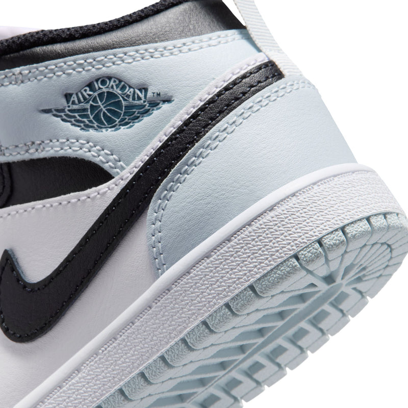 Kids mid-top sneaker close-up: Air Jordan logo, light blue heel accents, textured sole