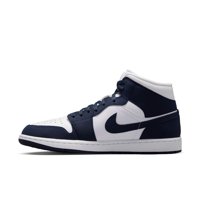 Side view of navy and white Air Jordan mid-top sneakers with prominent swoosh