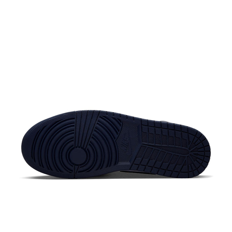Dark navy outsole of mid-top sneakers with textured tread pattern