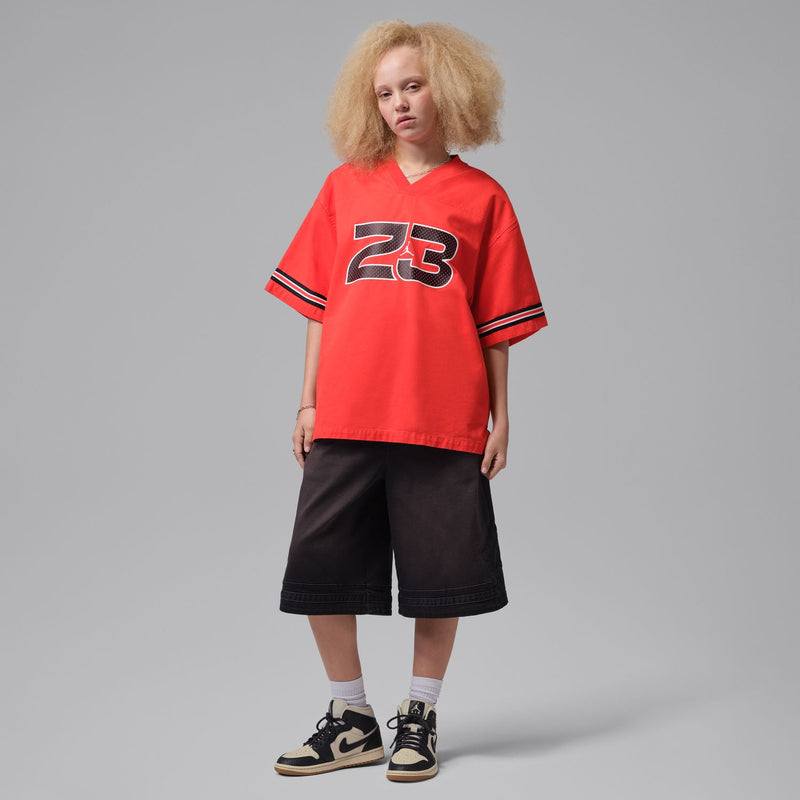 Women’s sneakers on model feet with black-and-off-white uppers and gum soles