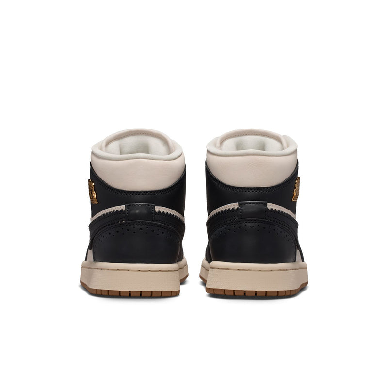 Back view of women’s mid-top sneakers with black heel panels and off-white lining