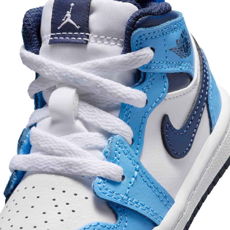 Close-up of toddler mid-top sneakers: white laces, light blue panels, navy swoosh