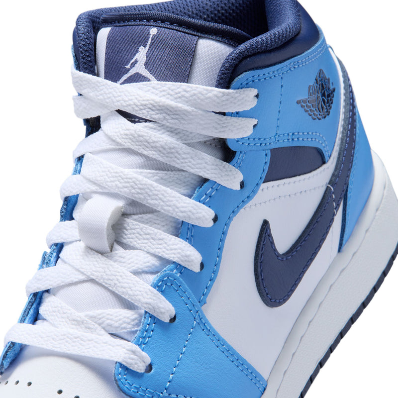Close-up of youth sneaker laces and collar, blue and white leather with navy swoosh.