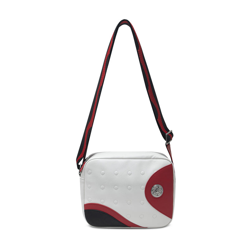 White crossbody messenger bag with adjustable straps and round red logo patch