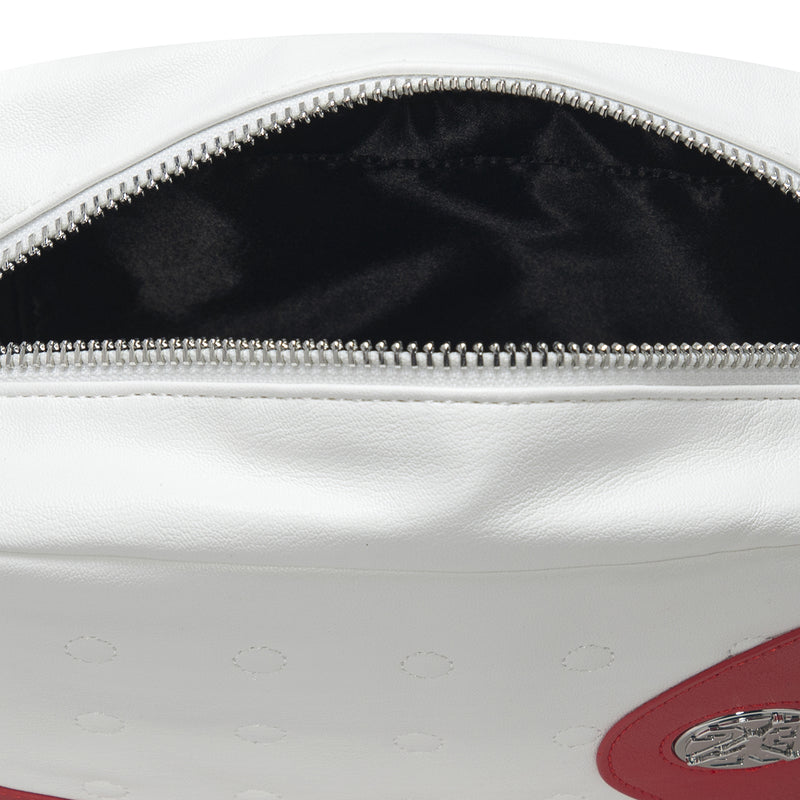 White bag interior with silver zipper and embossed leather texture