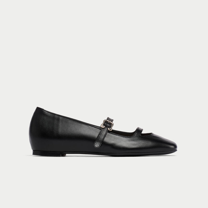 Black platform shoe with a strap on a white background