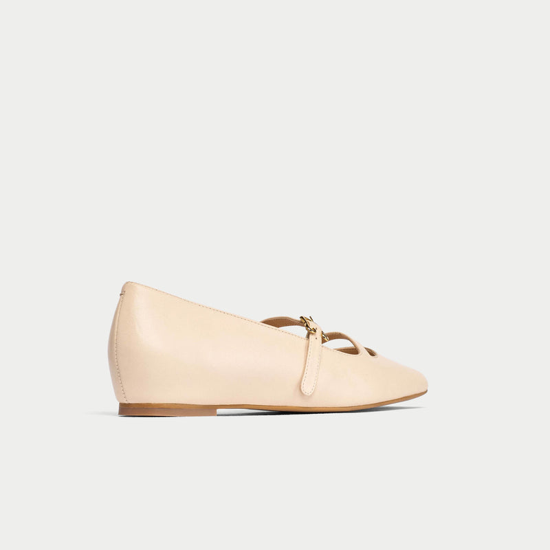 Beige flat shoe with on a light gray background