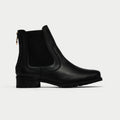 Black Chelsea boot on a light gray background