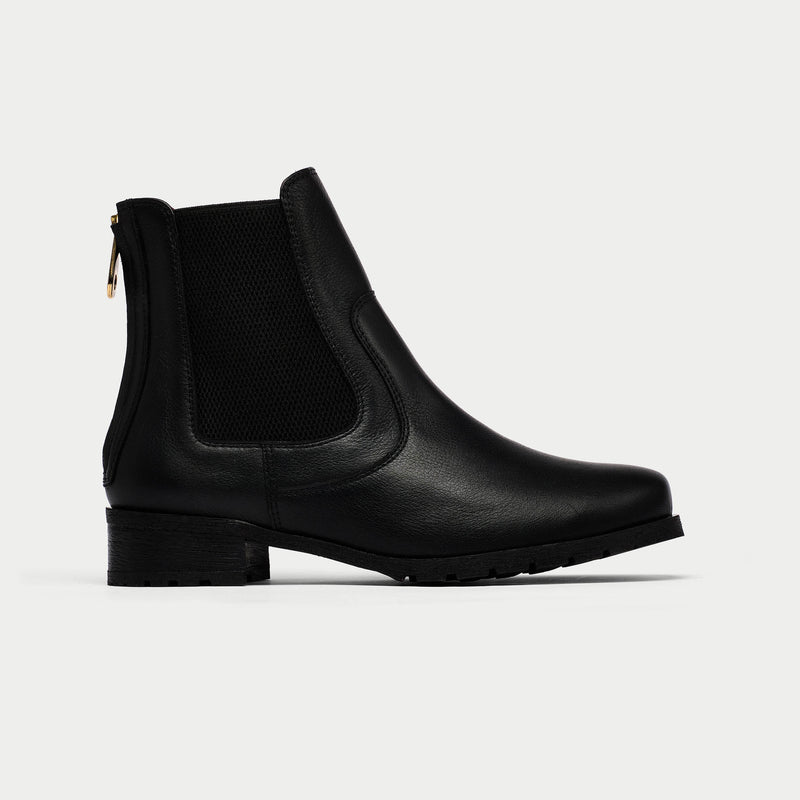 Black Chelsea boot on a light gray background