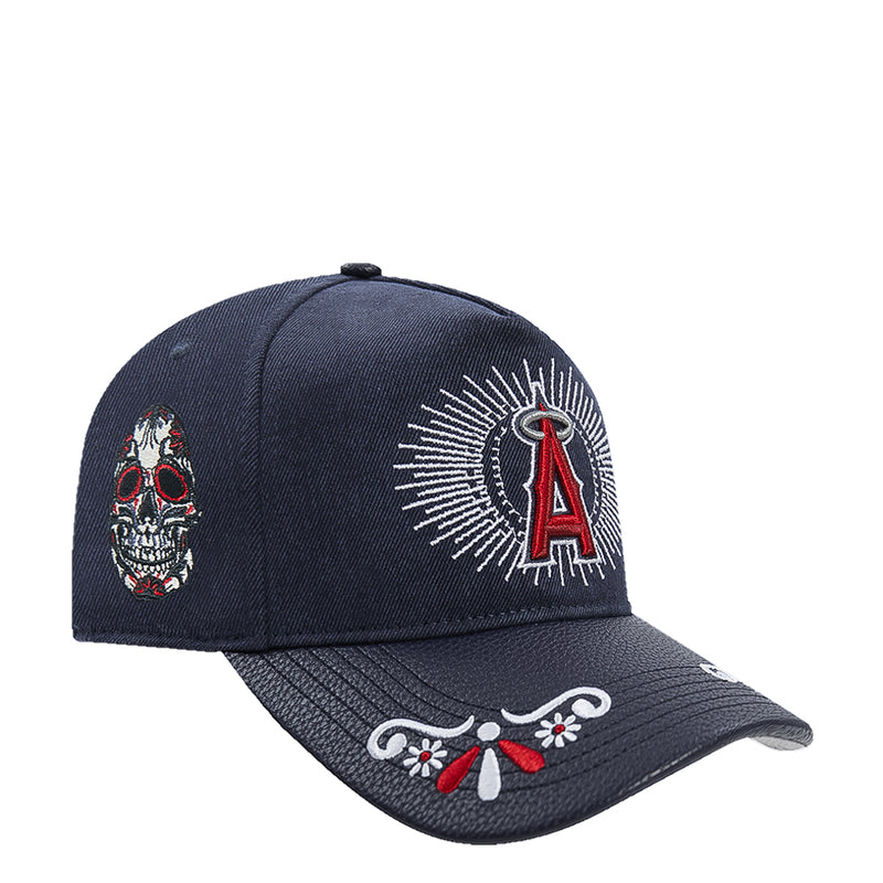 Navy strapback cap with front A emblem, small skull side patch, and floral brim trim
