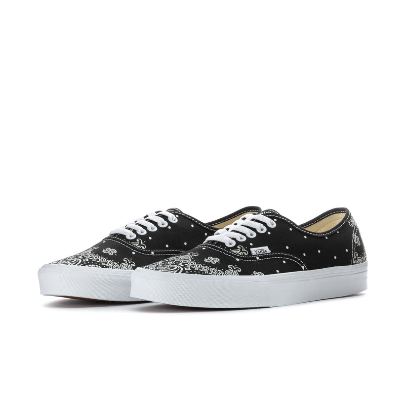 Black Vans low-top lace-up sneakers with white bandana print, side view