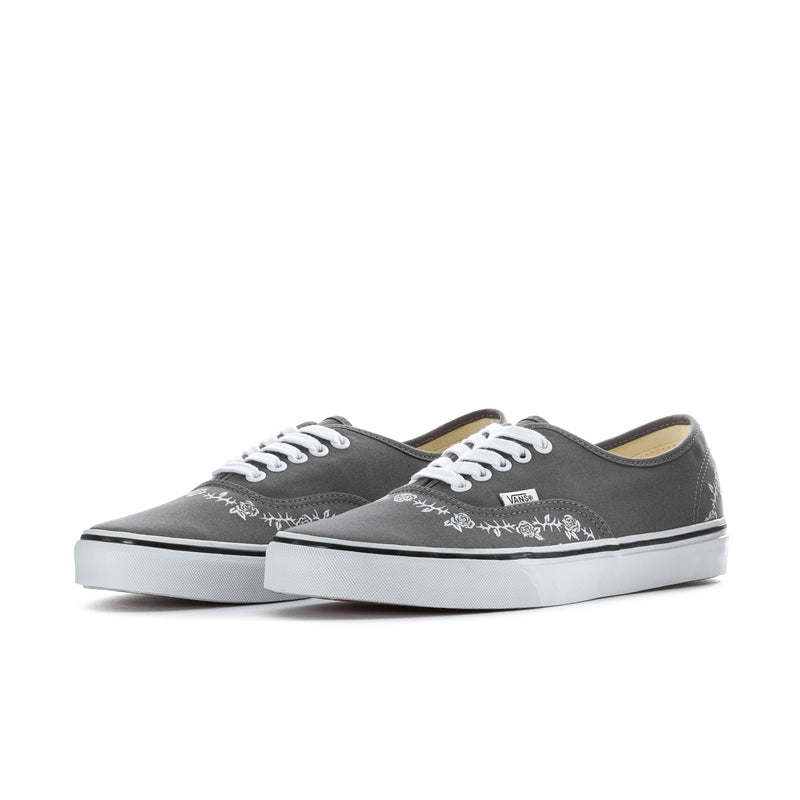 Pair of men's dark gray canvas low-top sneakers with white floral embroidery and laces