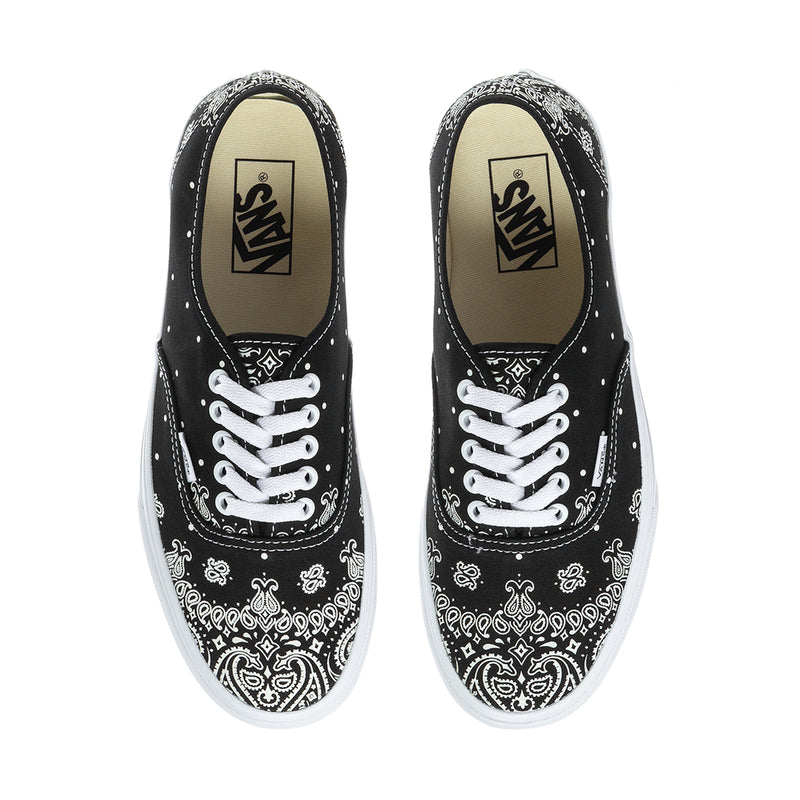 Pair of black Vans low-top sneakers with white bandana print and white laces