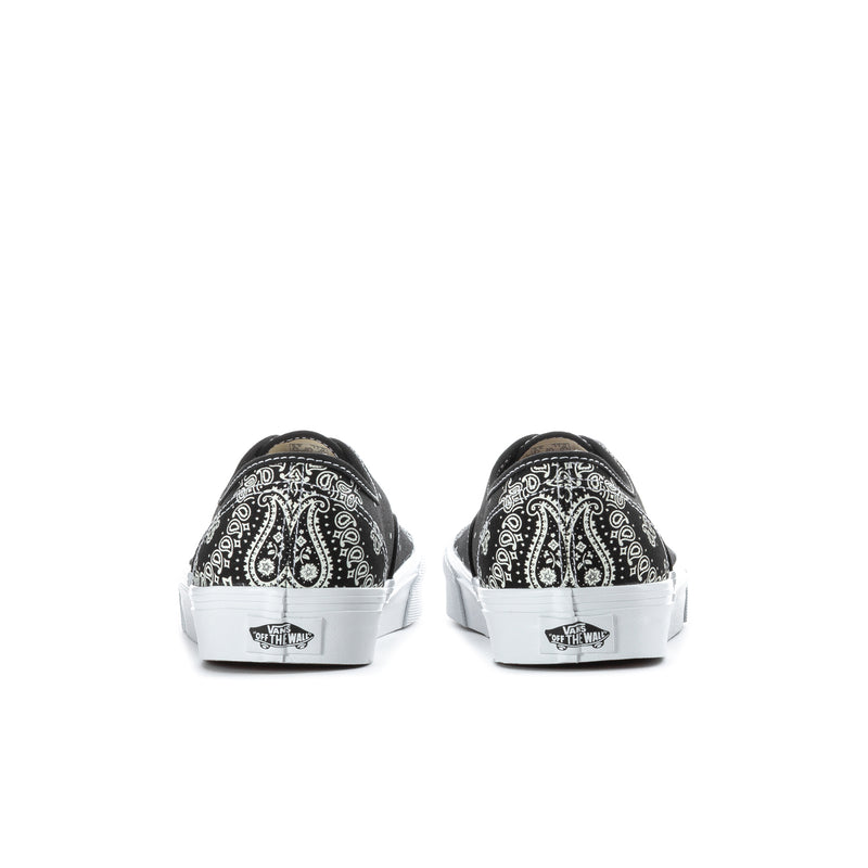 Black Vans low-top sneakers with white bandana print and white heel tabs