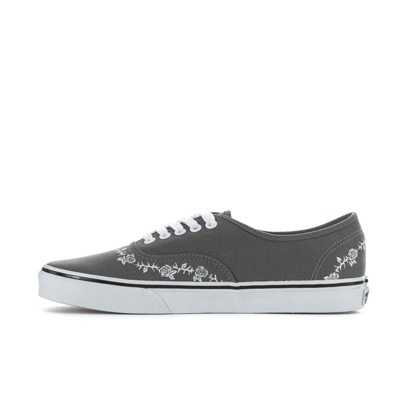Men's dark gray canvas low-top sneaker with white floral stripe across the side