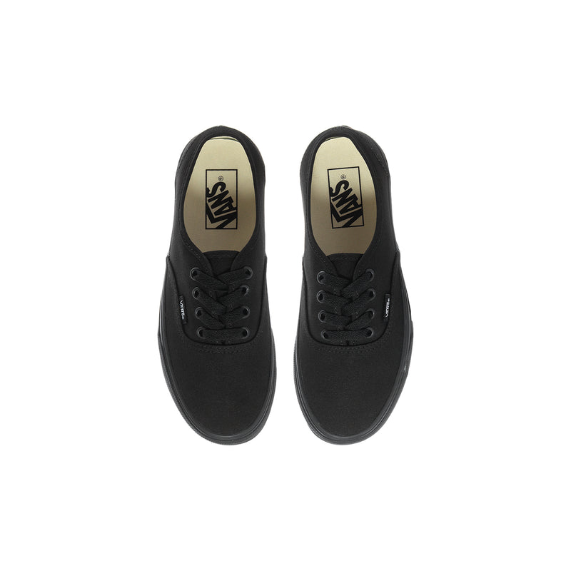 Pair of black youth sneakers with Vans logos on tongues and tan lining