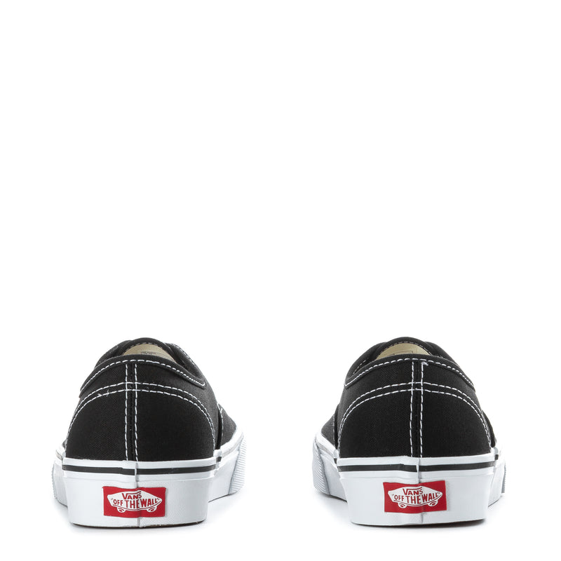 Youth black canvas sneakers, heel view with white Vans logo tag