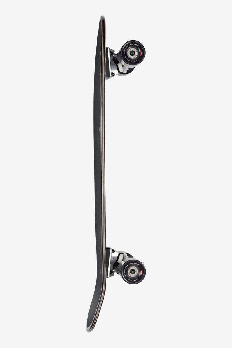 Side view of Melt 32 inch cruiser deck showing kick tail, black finish, and mounted trucks