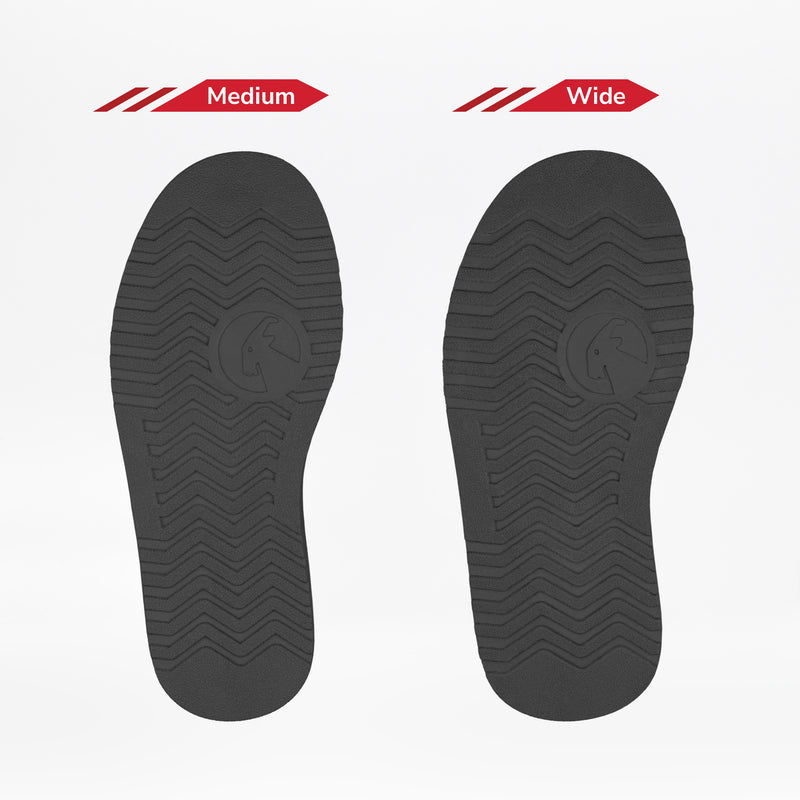 Two Black BILLY Cozy II soles by BILLY Footwear for women’s boots are shown on a white background: the left sole is Medium, the right is Wide. Both feature identical tread patterns, but the Wide version is broader than the Medium.