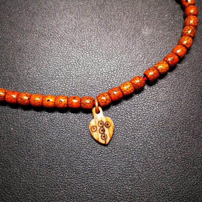 Bone Carved Nubro Pendant - Tibetan Buddhist art, close-up detail