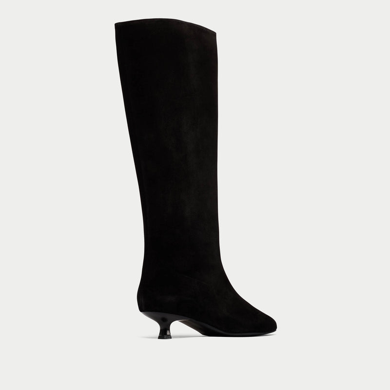 Black knee-high boot on a light gray background