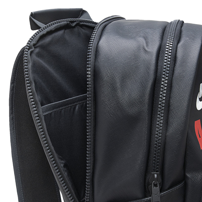 Black backpack with side zipper, textured finish, and padded back panel.