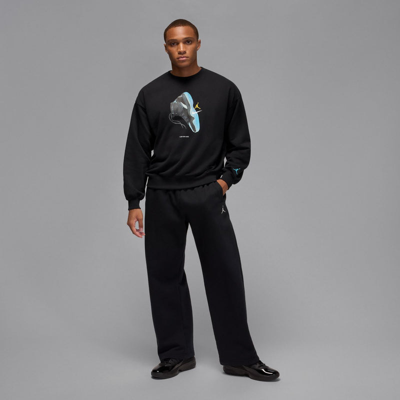 Black crewneck sweatshirt with blue sneaker graphic and small wrist Jumpman logo