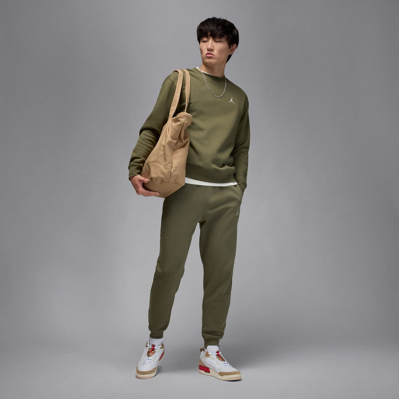 Men's medium olive fleece pants, side view, tapered jogger silhouette