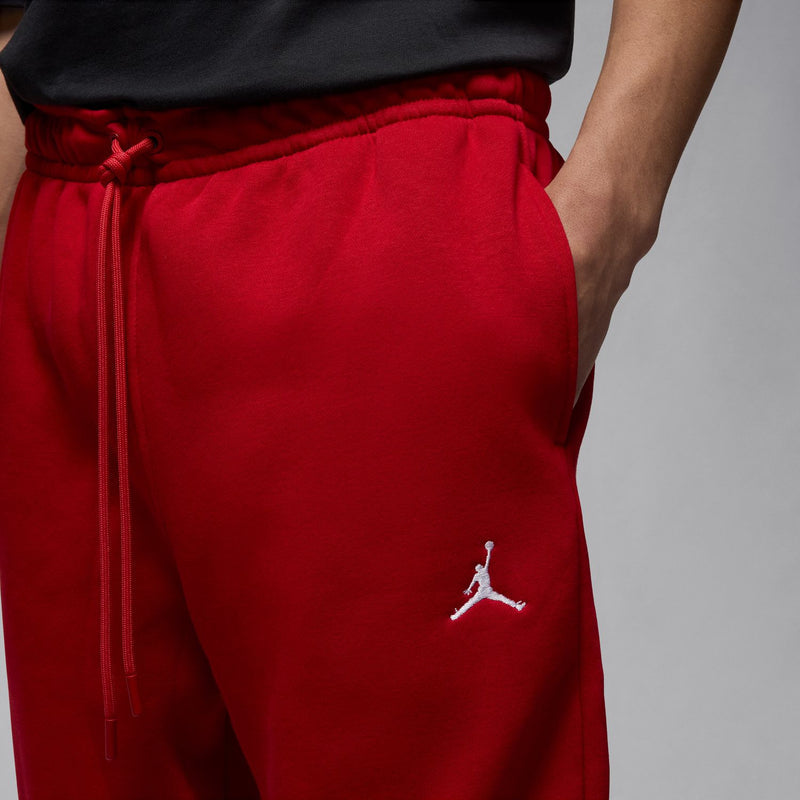 Men’s red fleece jogger pants with drawstring waist and embroidered Jumpman logo