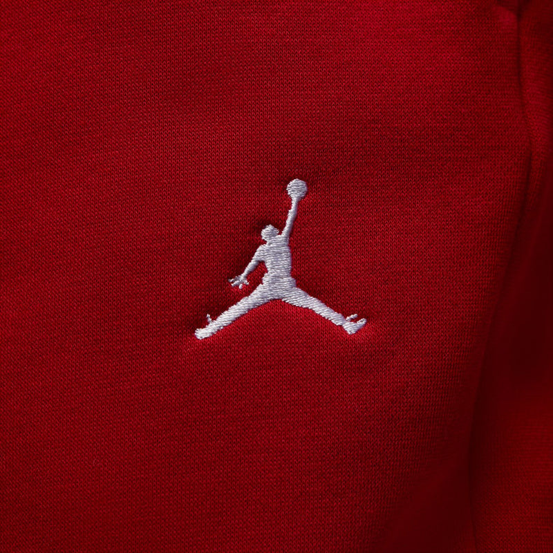 Close-up of embroidered Jumpman logo on red fleece pants