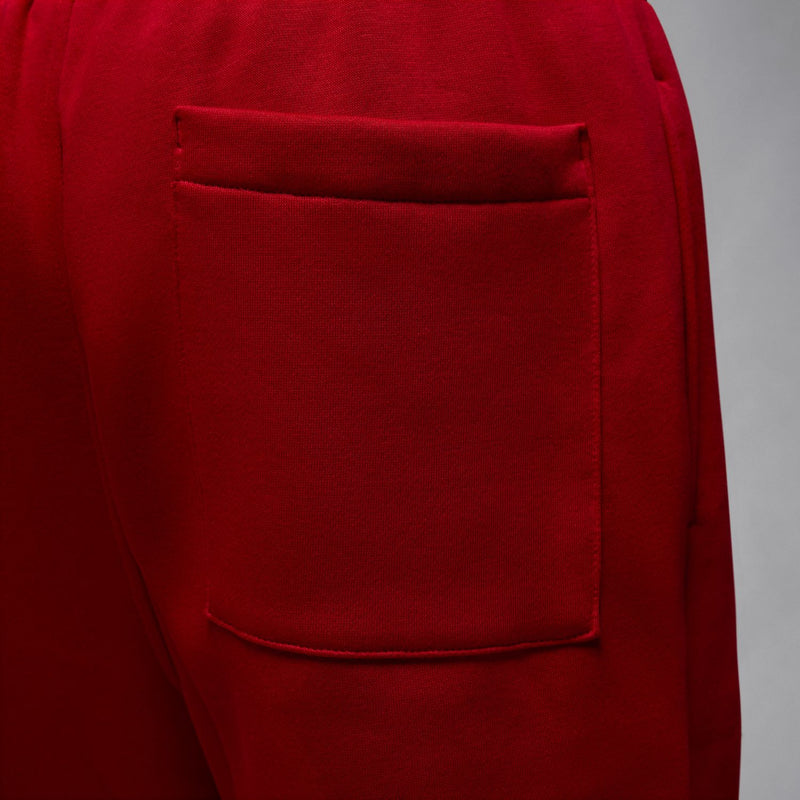Red fleece pants back pocket detail with visible seam stitching