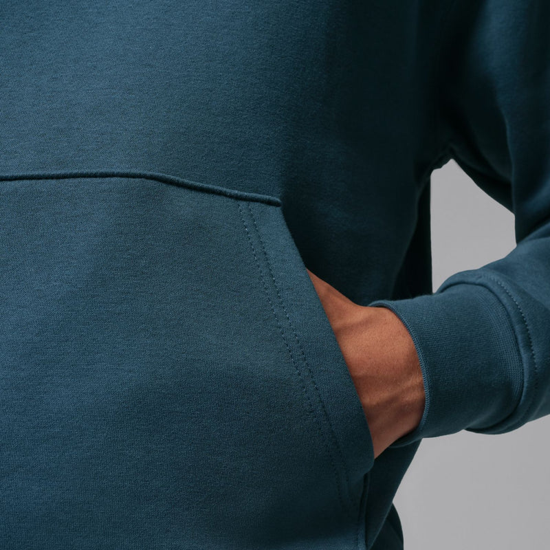 Men's squadron blue fleece hoodie detail: kangaroo pocket and ribbed sleeve cuff.