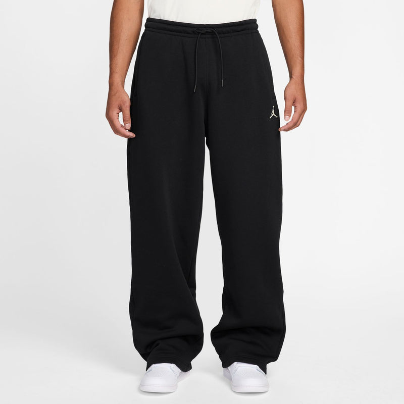 Black drawstring lounge pants with cuffed hem and small chest logo on thigh