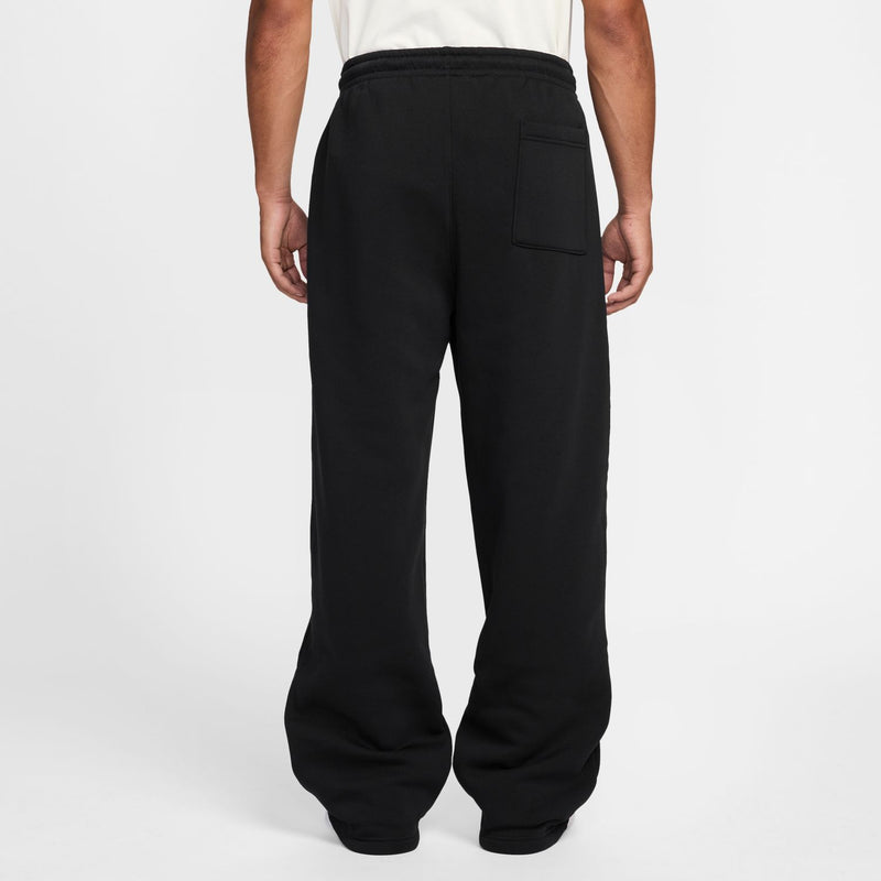Black oversized OH pants with relaxed wide legs and side pockets; cuffed hem