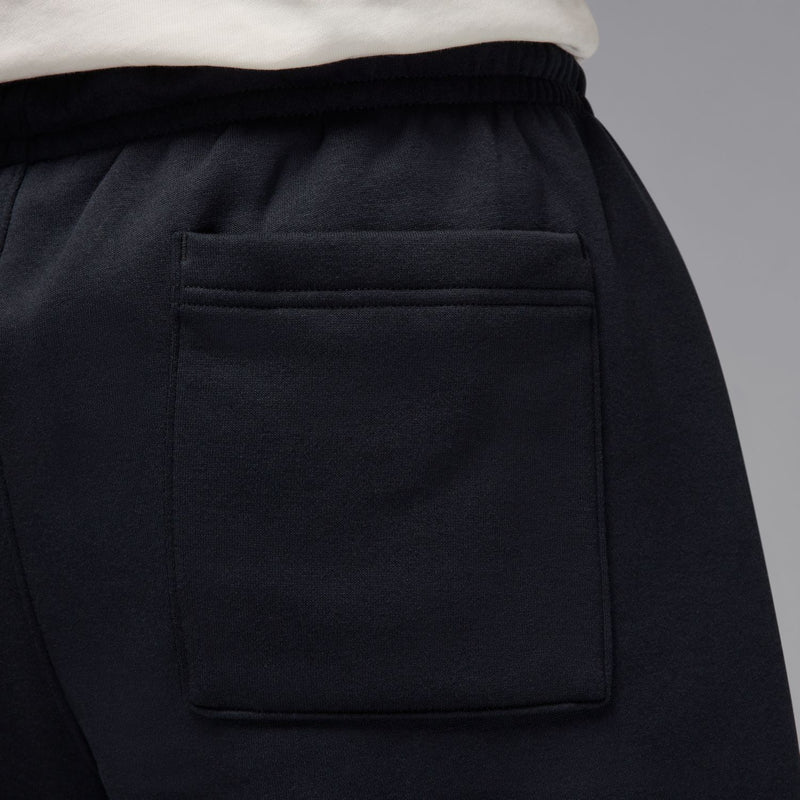 Black OH pant close-up: elastic waistband and square side pocket with stitching